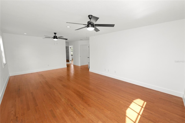 empty room with recessed lighting, ceiling fan, light wood-style flooring, and baseboards