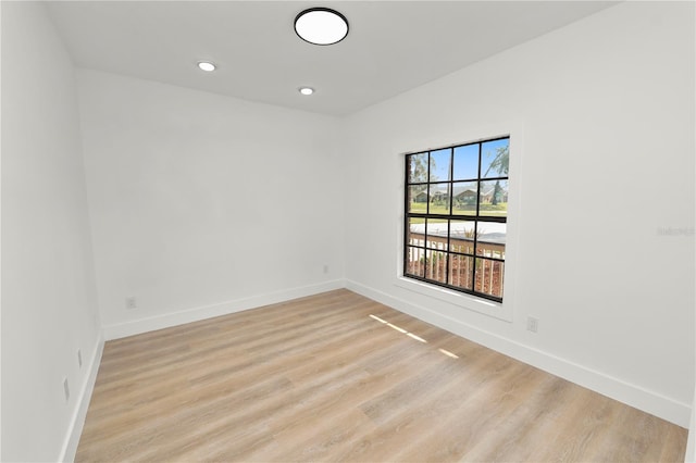 unfurnished room featuring recessed lighting, baseboards, and light wood finished floors