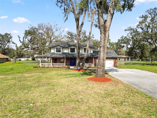 view of front of property featuring a porch, brick siding, fence, and a front lawn