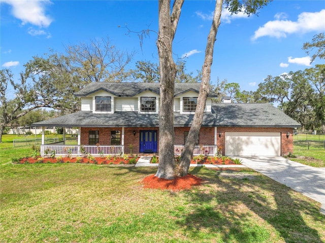 country-style home with a porch, a front yard, brick siding, and a garage