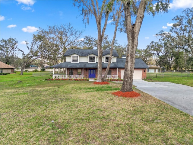 view of front of home with fence, a front lawn, a porch, and brick siding