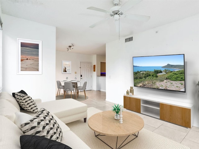 tiled living room with ceiling fan