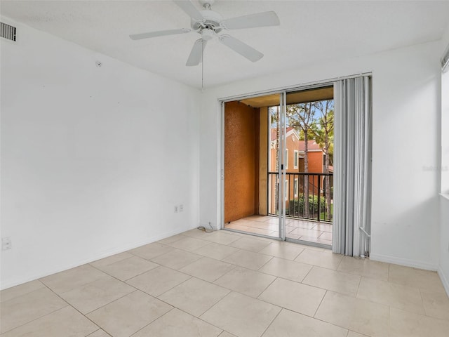 spare room featuring light tile patterned floors and ceiling fan