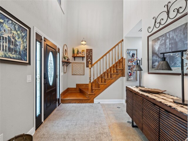 tiled foyer featuring a high ceiling