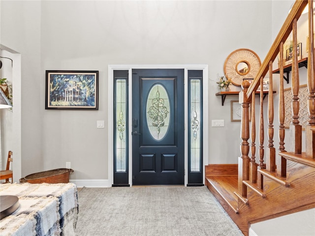 view of carpeted foyer entrance