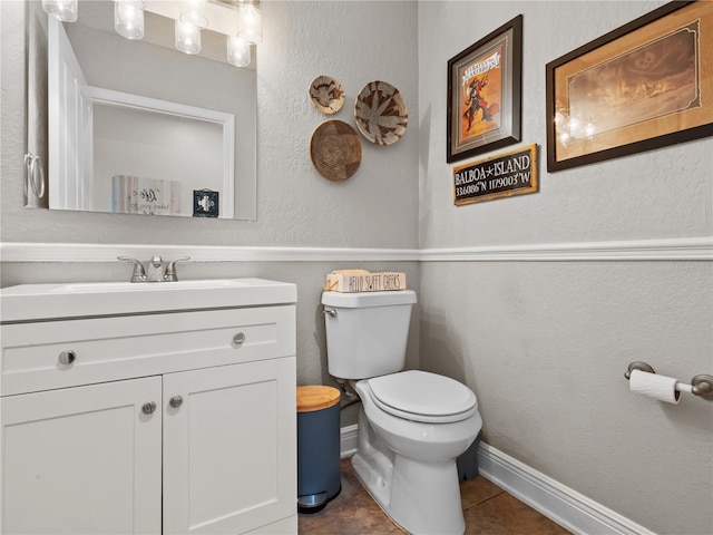 bathroom with vanity, tile patterned floors, and toilet