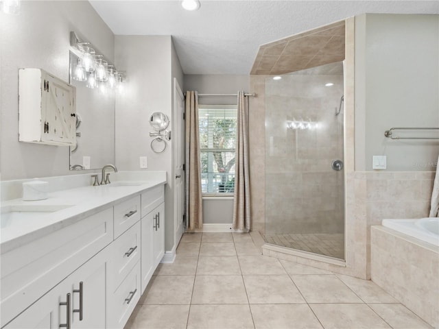 bathroom with tile patterned flooring, plus walk in shower, and vanity