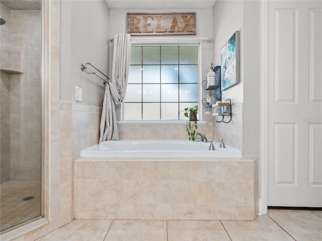 bathroom with tile patterned flooring and separate shower and tub