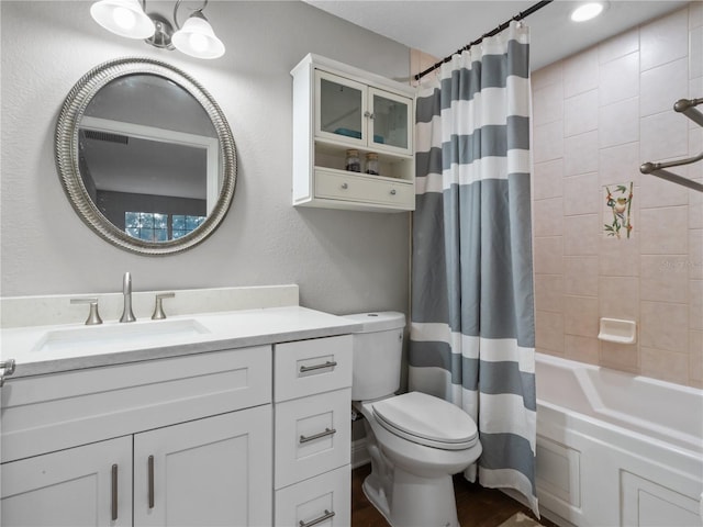 full bathroom featuring shower / bath combo, vanity, and toilet