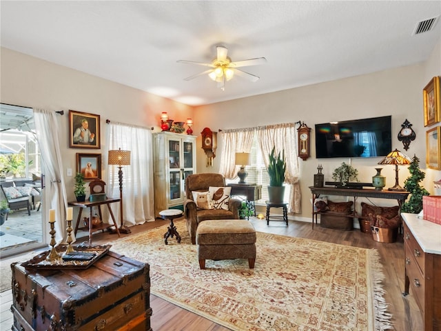 living room with wood-type flooring, a healthy amount of sunlight, and ceiling fan