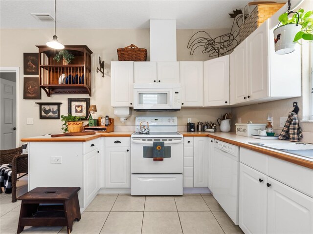 kitchen with white cabinetry, light tile patterned floors, white appliances, and decorative light fixtures