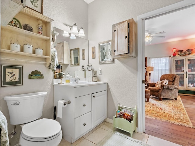 bathroom featuring vanity, ceiling fan, hardwood / wood-style flooring, and toilet