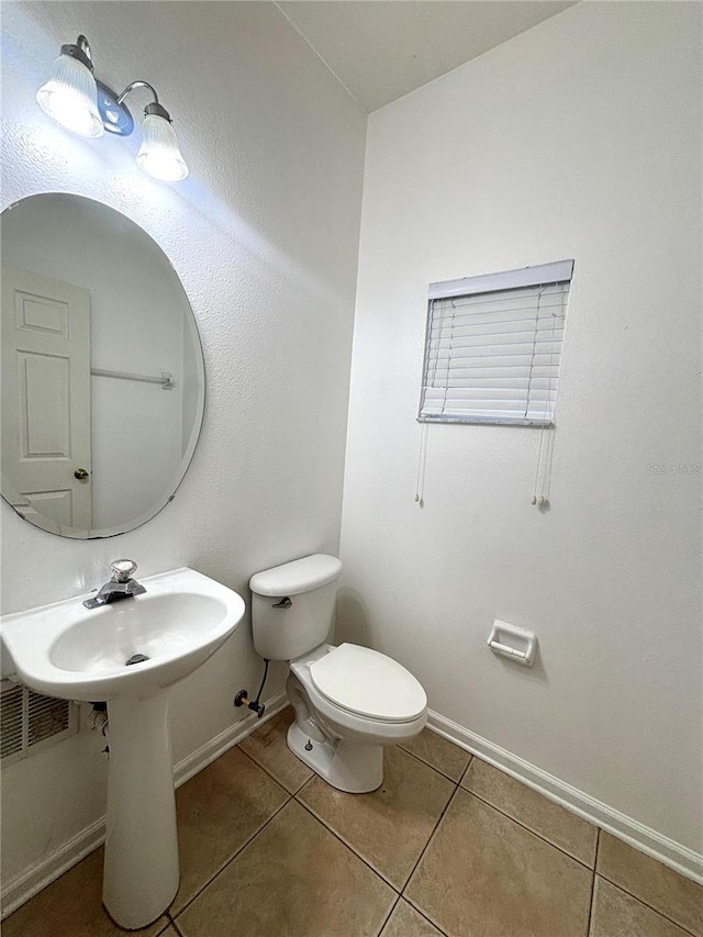 bathroom featuring tile patterned flooring and toilet