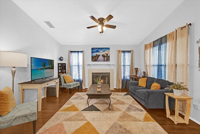 living room with vaulted ceiling, a wealth of natural light, and wood finished floors