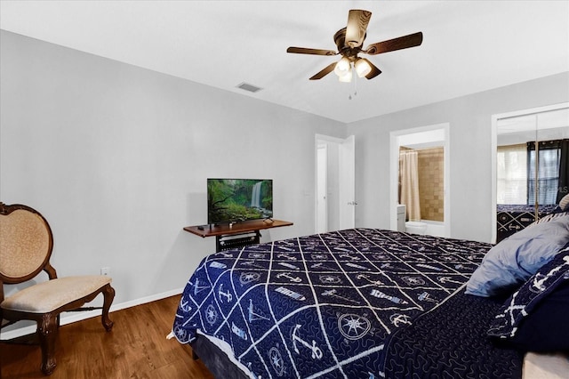 bedroom featuring baseboards, visible vents, ceiling fan, and wood finished floors