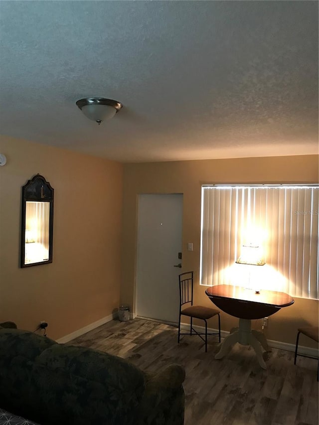 bedroom with hardwood / wood-style flooring and a textured ceiling