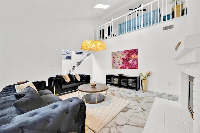5108 Avignon Ct, Orlando, FL 32839 - living area with marble look tiles, stairs, a high ceiling, a brick fireplace, and a skylight