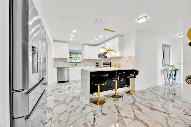 5108 Avignon Ct, Orlando, FL 32839 - kitchen featuring stainless steel appliances, light countertops, tasteful backsplash, white cabinetry, and a peninsula
