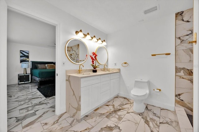 5108 Avignon Ct, Orlando, FL 32839 - bathroom featuring marble finish flooring, double vanity, baseboards, toilet, and ensuite bath