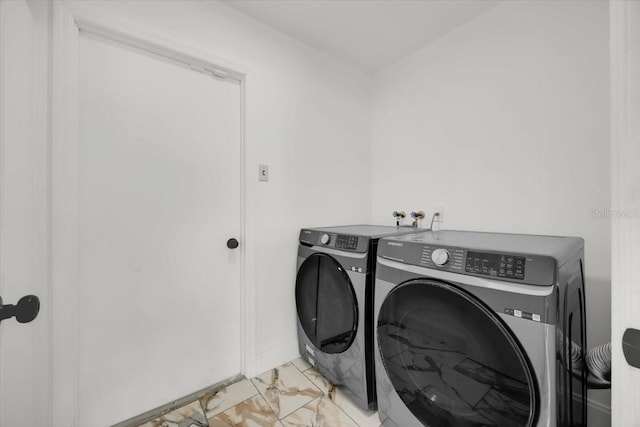 5108 Avignon Ct, Orlando, FL 32839 - washroom featuring washer and dryer and light marble finish floors