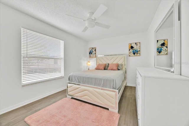 5108 Avignon Ct, Orlando, FL 32839 - bedroom with wood finished floors, a ceiling fan, baseboards, and a textured ceiling