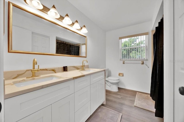5108 Avignon Ct, Orlando, FL 32839 - full bath with toilet, double vanity, wood finished floors, and baseboards