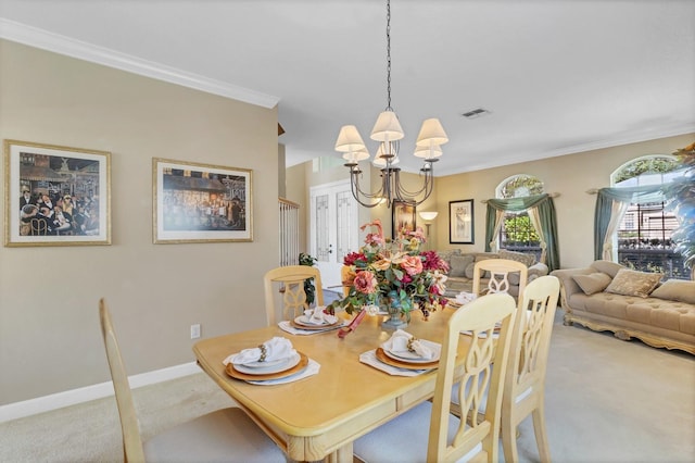 dining room with crown molding, light carpet, and a notable chandelier