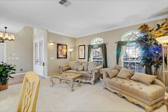 carpeted living room with crown molding and a chandelier