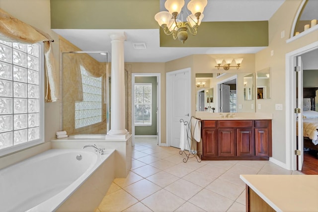 bathroom with an inviting chandelier, tile patterned floors, shower with separate bathtub, and decorative columns