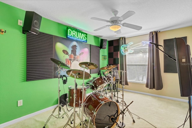 game room with ceiling fan, carpet, and a textured ceiling