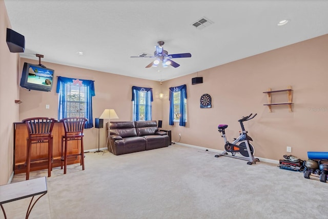 exercise area featuring carpet and ceiling fan