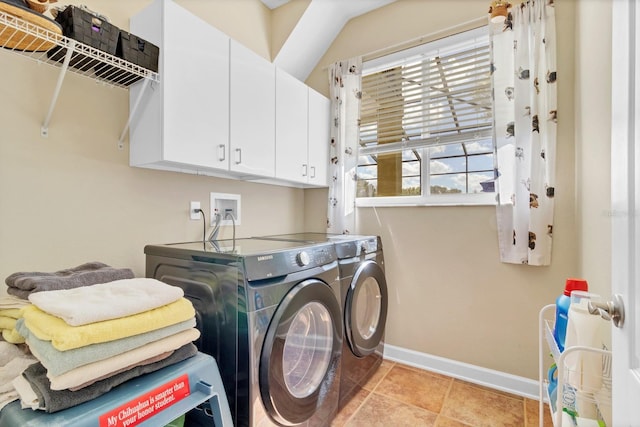 clothes washing area with cabinets, separate washer and dryer, and light tile patterned floors