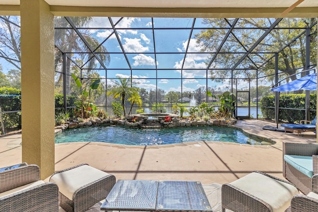 view of pool with a patio and glass enclosure