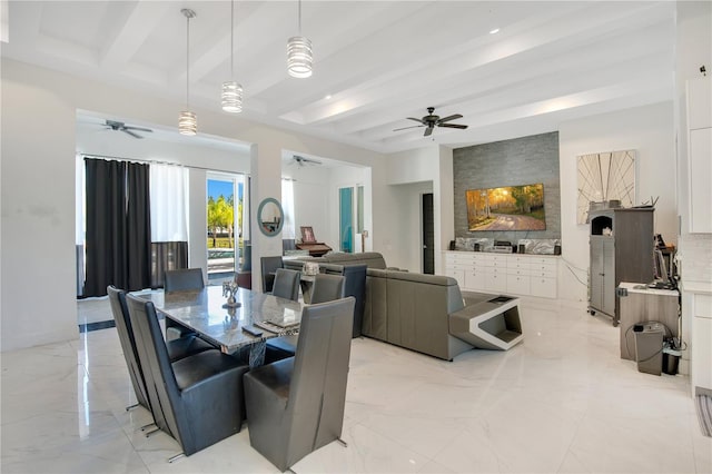 dining space with a ceiling fan, marble finish floor, and beamed ceiling