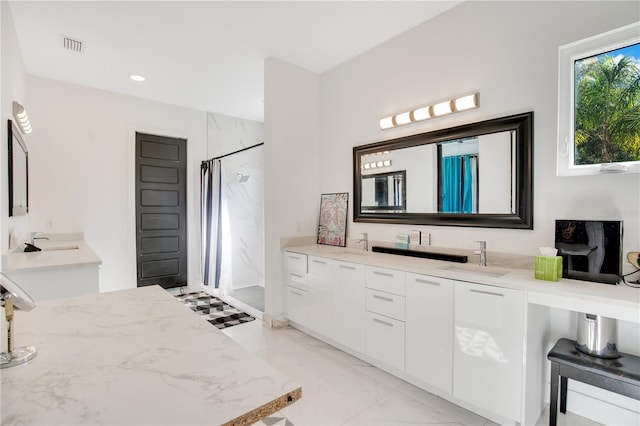 full bath with marble finish floor, vanity, visible vents, and a shower with shower curtain