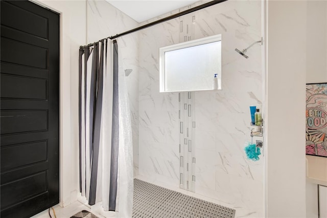 bathroom with a marble finish shower