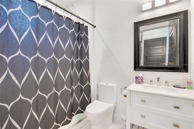 bathroom featuring curtained shower, marble finish floor, vanity, and toilet