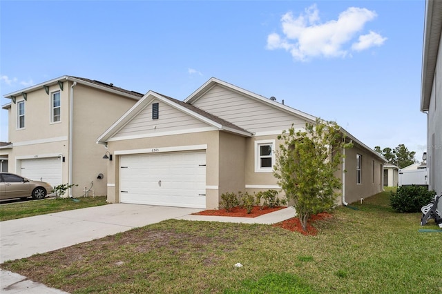 view of front of house with a garage and a front yard