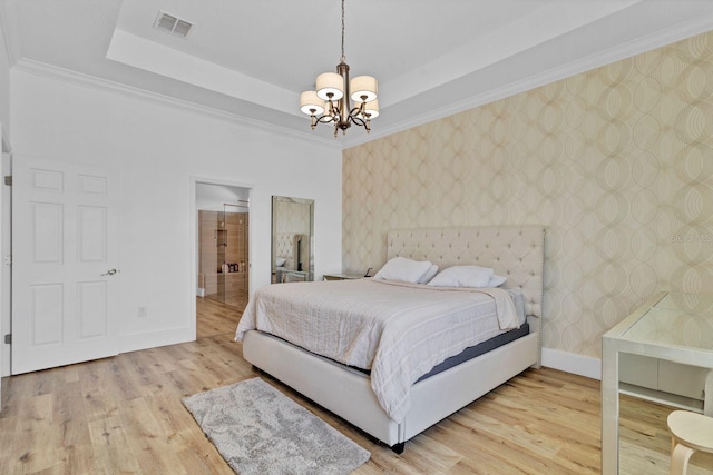 bedroom with a raised ceiling, visible vents, baseboards, and wallpapered walls