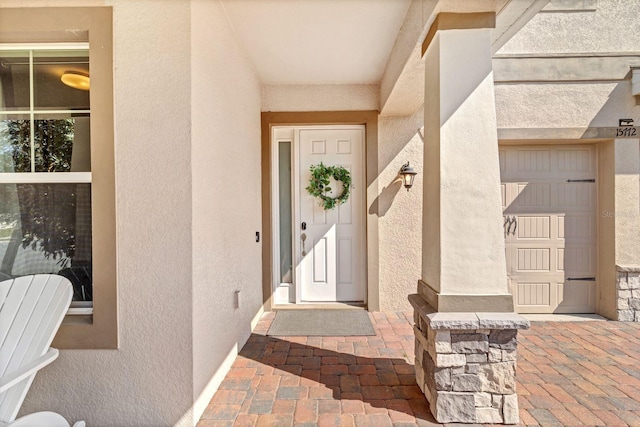 property entrance with stucco siding