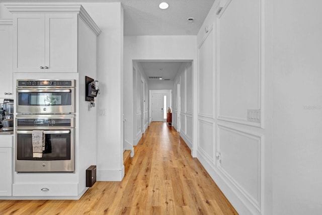 hall with light wood-style floors