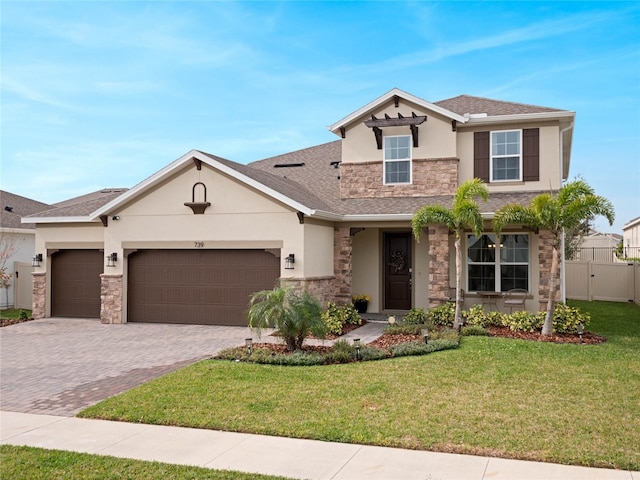 view of front facade with a garage, stone siding, stucco siding, decorative driveway, and a front yard