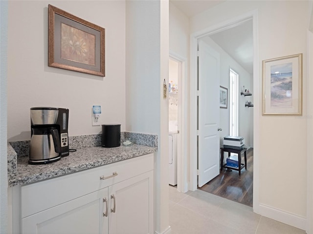 interior space with baseboards and light tile patterned floors