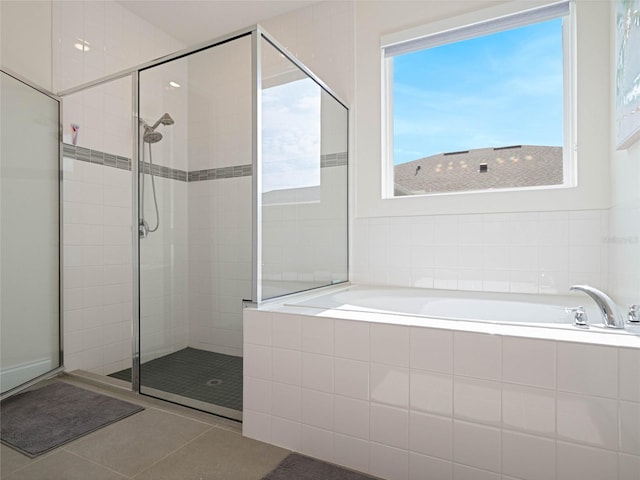 full bathroom with a stall shower, tile patterned flooring, plenty of natural light, and a bath