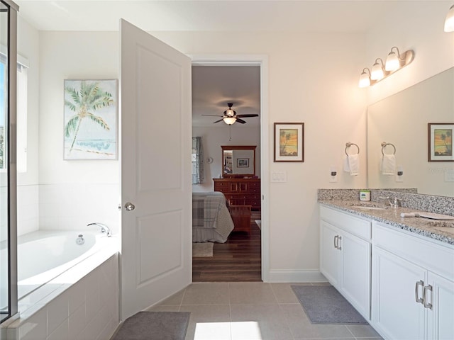 ensuite bathroom featuring a garden tub, ensuite bathroom, a ceiling fan, vanity, and tile patterned floors