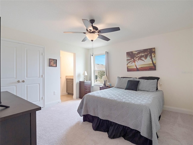 bedroom with ceiling fan, baseboards, a closet, and light colored carpet