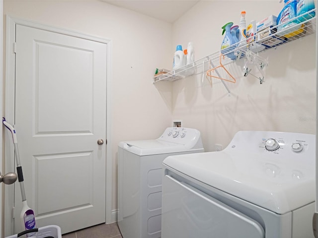 laundry room with laundry area, light tile patterned floors, and washer and dryer