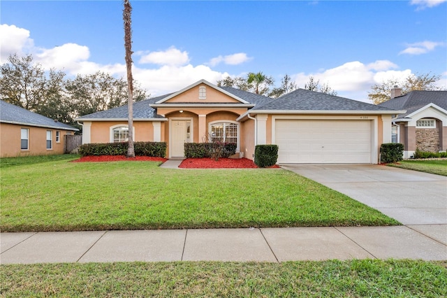 single story home with a garage and a front lawn