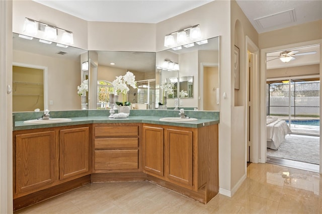 bathroom with vanity, an enclosed shower, and ceiling fan