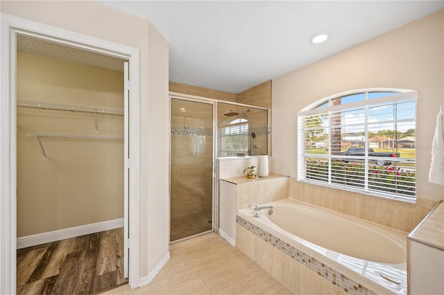 bathroom with shower with separate bathtub